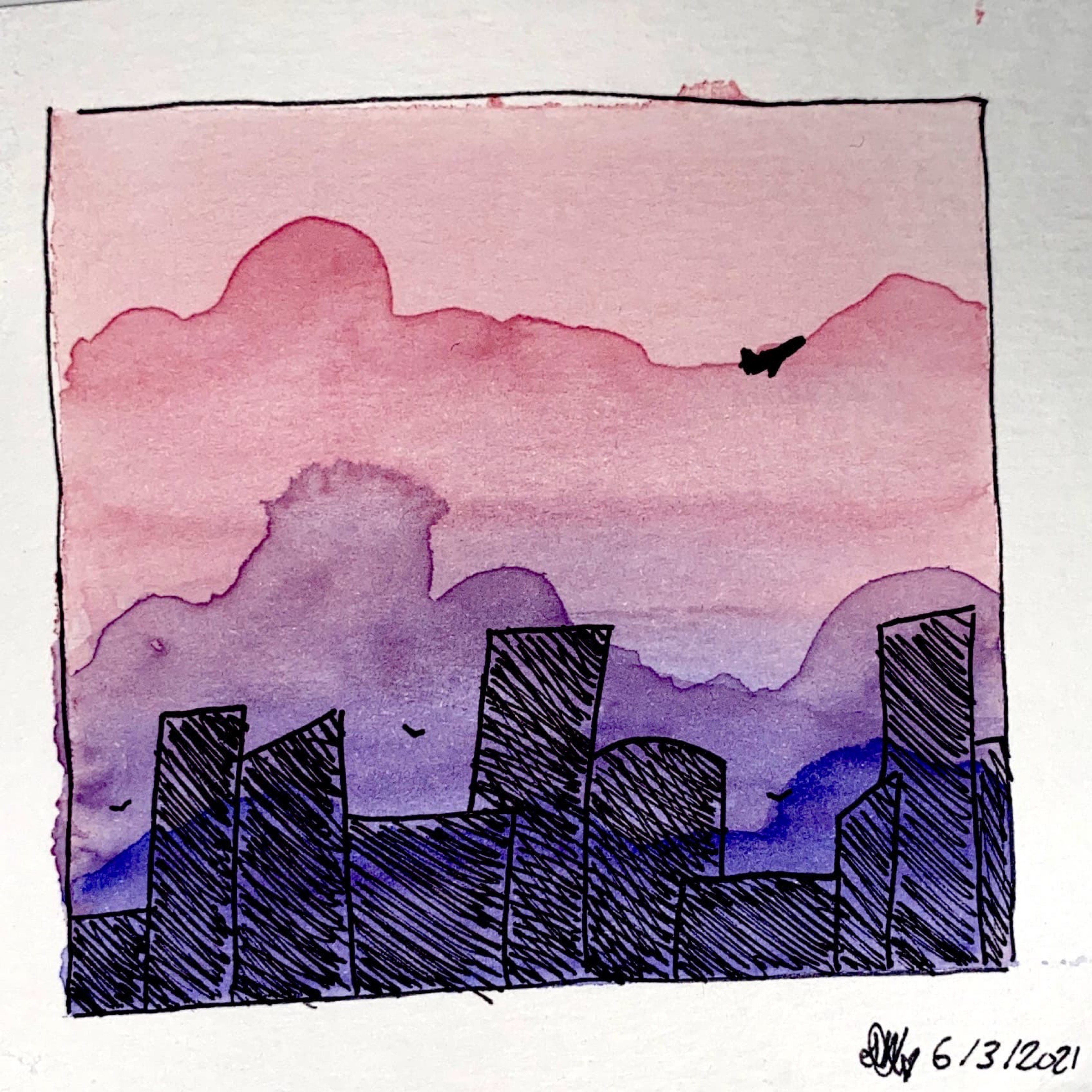 a pink sunset over a city skyline